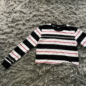 100% cotton “Lurking Class” but from Zumiez. Sort of cropped but covers torso